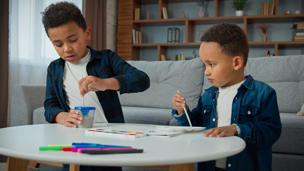 two brothers who are painting - Level Up Wellness Group two little boys who are BIPOC, art therapy, Alberta, Canada