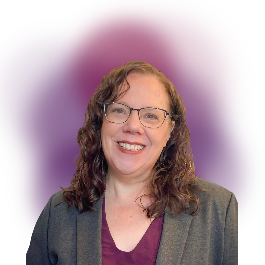 Smiling woman with glasses wearing a gray blazer and purple top, posed against a purple gradient backdrop in a professional headshot.